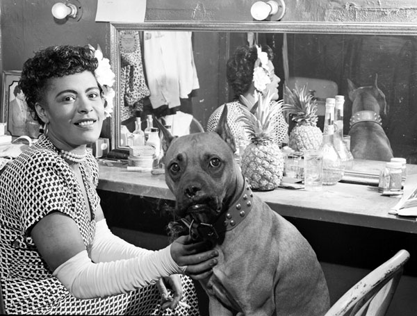 Billie Holiday and her dog Mister, backstage dressing room, probably at the Downbeat, NYC. June, 1946 by William P. Gottlieb